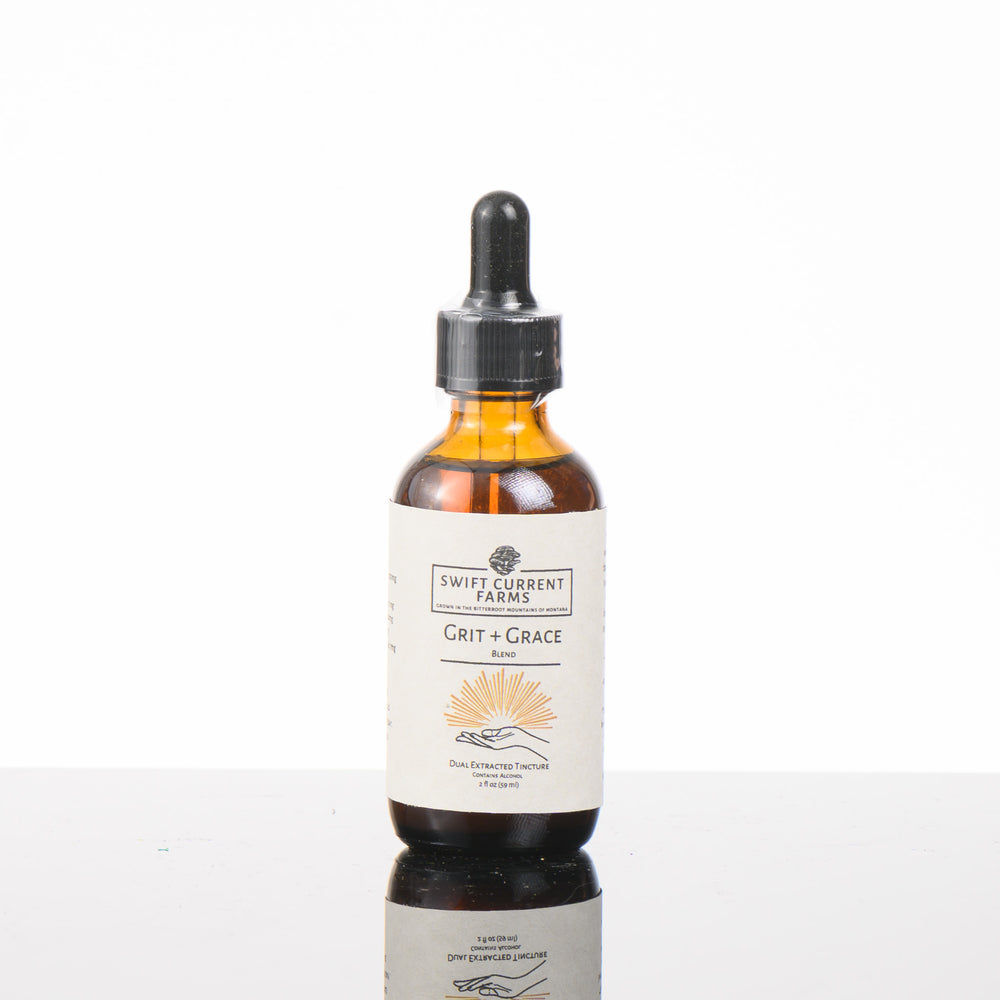 a 2oz bottle of Swift Current Farms' Grit and Grace Blend Tincture, a masterful fusion of premium mushrooms.