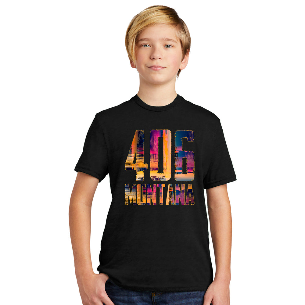 A young boy wearing a black tshirt printed with our 406 Montana design