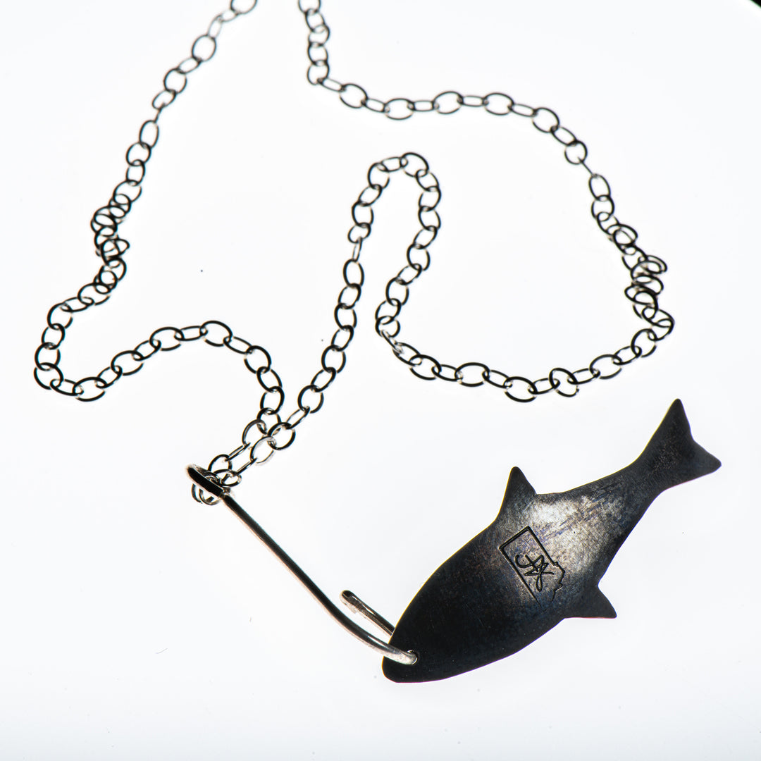 Cobble Stone Designs of Montana's Copper Fish with Sterling Silver Hook Necklace, a fun fishing-inspired silver and copper necklace made in Montana