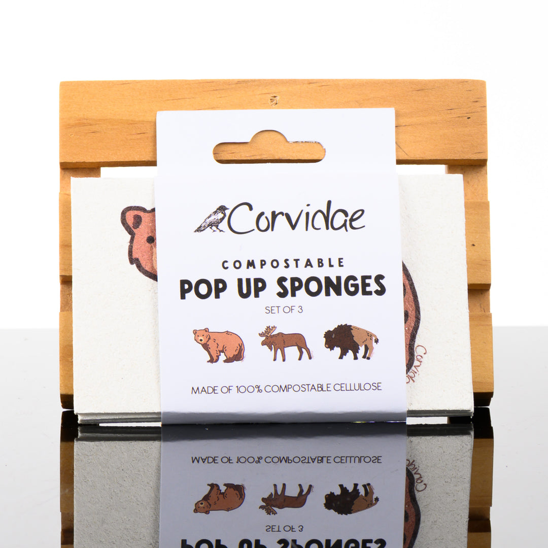 A set of three compostable pop up sponges with a bear, moose and bison design, hand drawn by Corvidae in Montana.