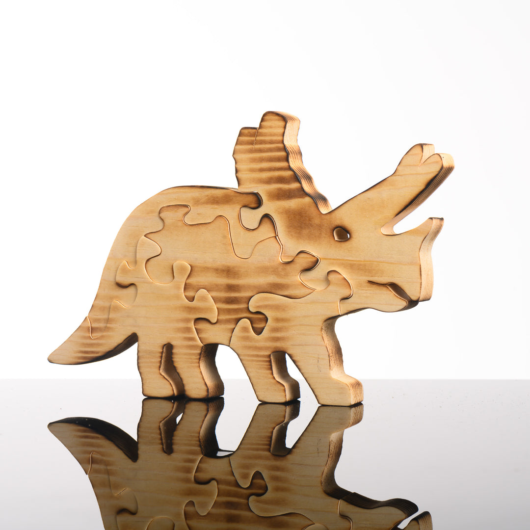 This handmade wood kids puzzle is of a triceratops.