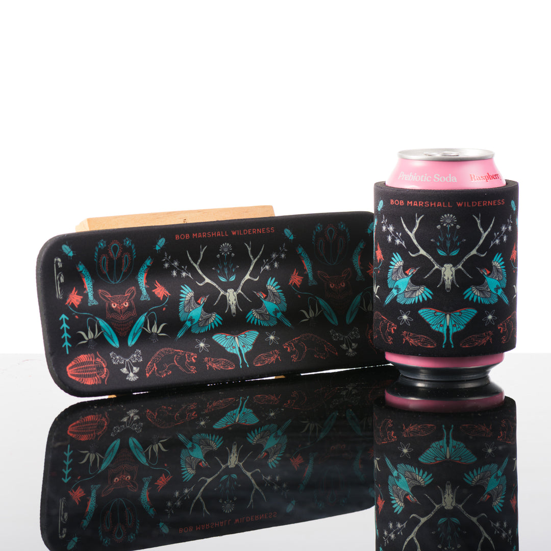 This black slap can cooler features, hand drawn art inspired by the Bob Marshall Wilderness in Montana.