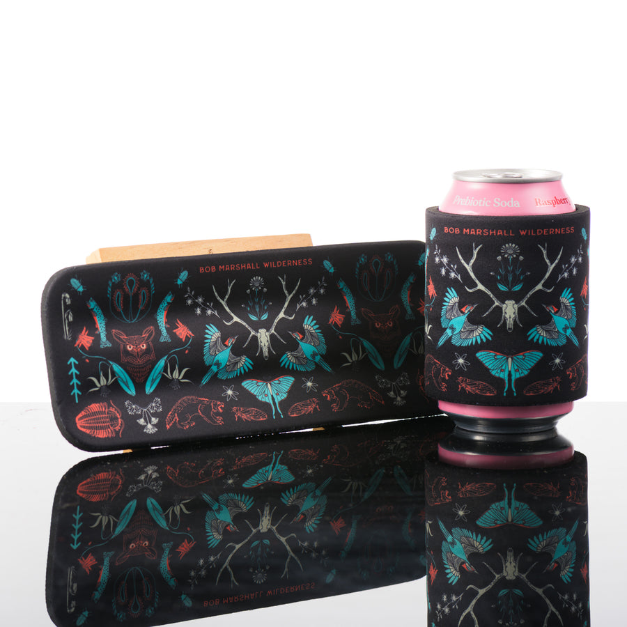 This black slap can cooler features, hand drawn art inspired by the Bob Marshall Wilderness in Montana.