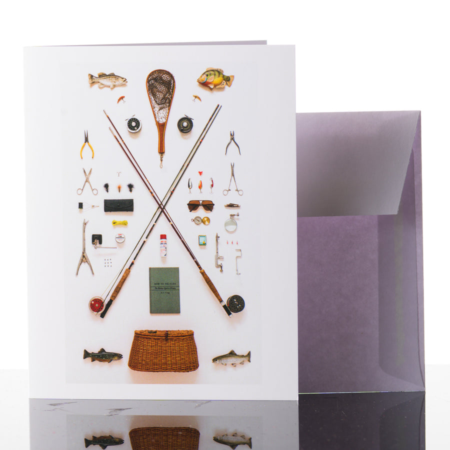 This 4.25" x 5.5" greeting card features a flat lay photograph of vintage fishing gear.