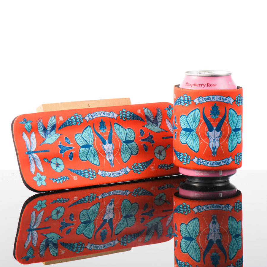 This orange and blue slap can cooler features art inspired by Going to the Sun Road in Glacier National Park.