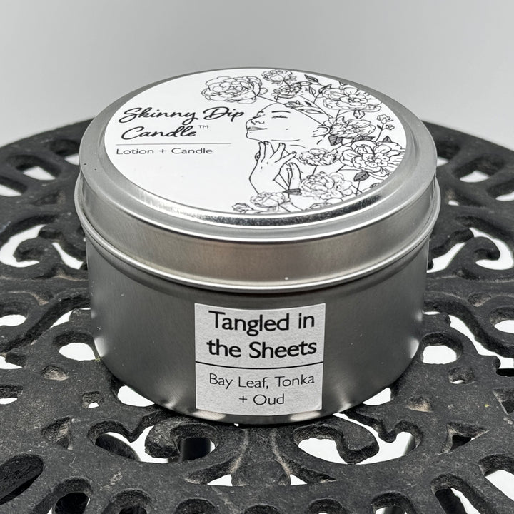 4 oz. tin of Skinny Dip Candle's Tangled in the Sheets Lotion Candle, front