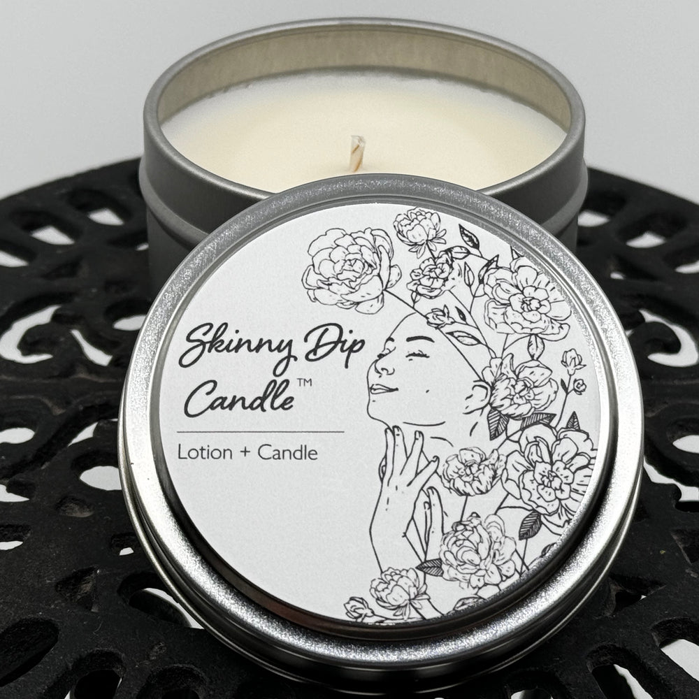 4 oz. tin of Skinny Dip Candle's Mountain Rain Lotion Candle, lid and inside