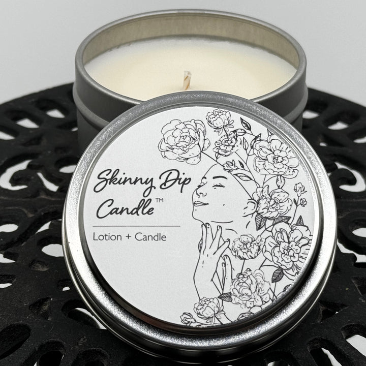 4 oz. tin of Skinny Dip Candle's Tangled in the Sheets Lotion Candle, lid and inside