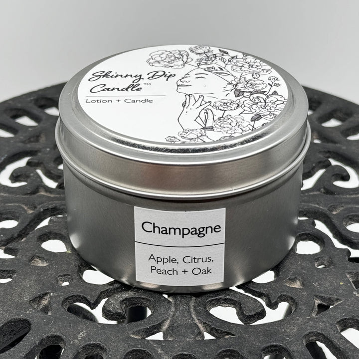 4 oz. tin of Skinny Dip Candle's Champagne Lotion Candle, front