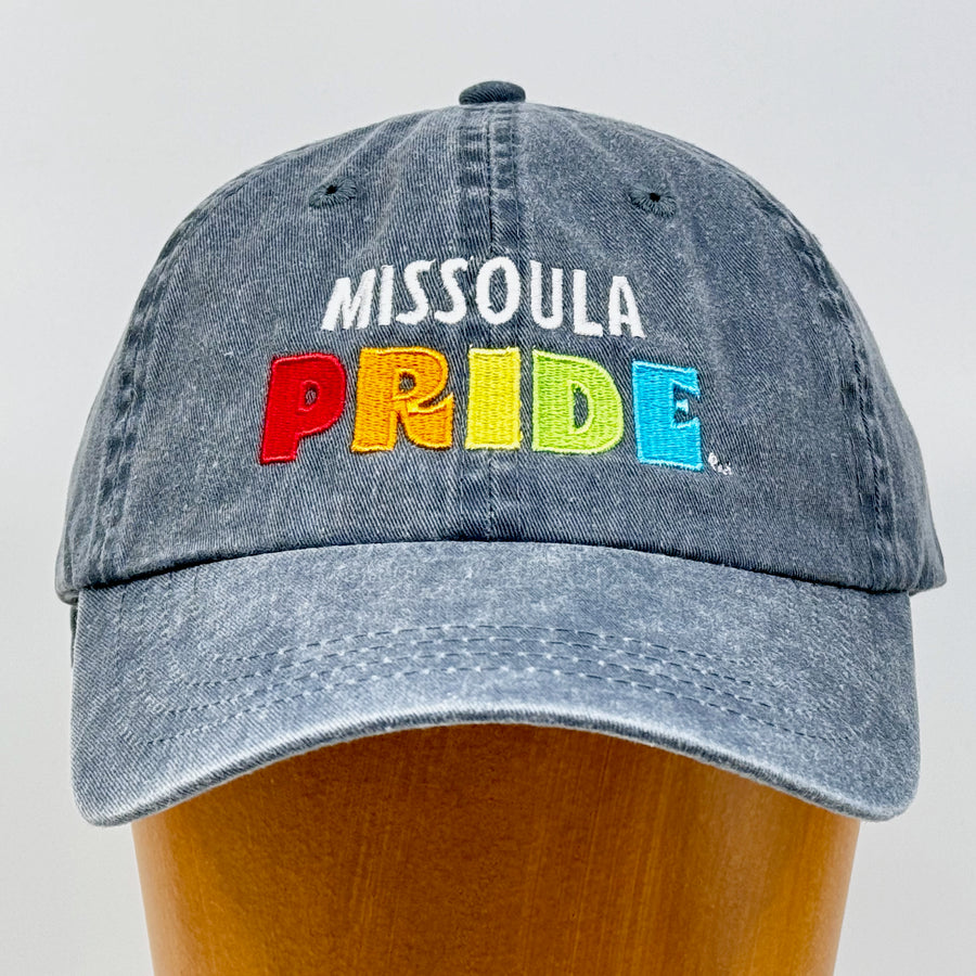 Charcoal grey pigment dyed unstructured hat featuring the Missoula PRIDE logo, front