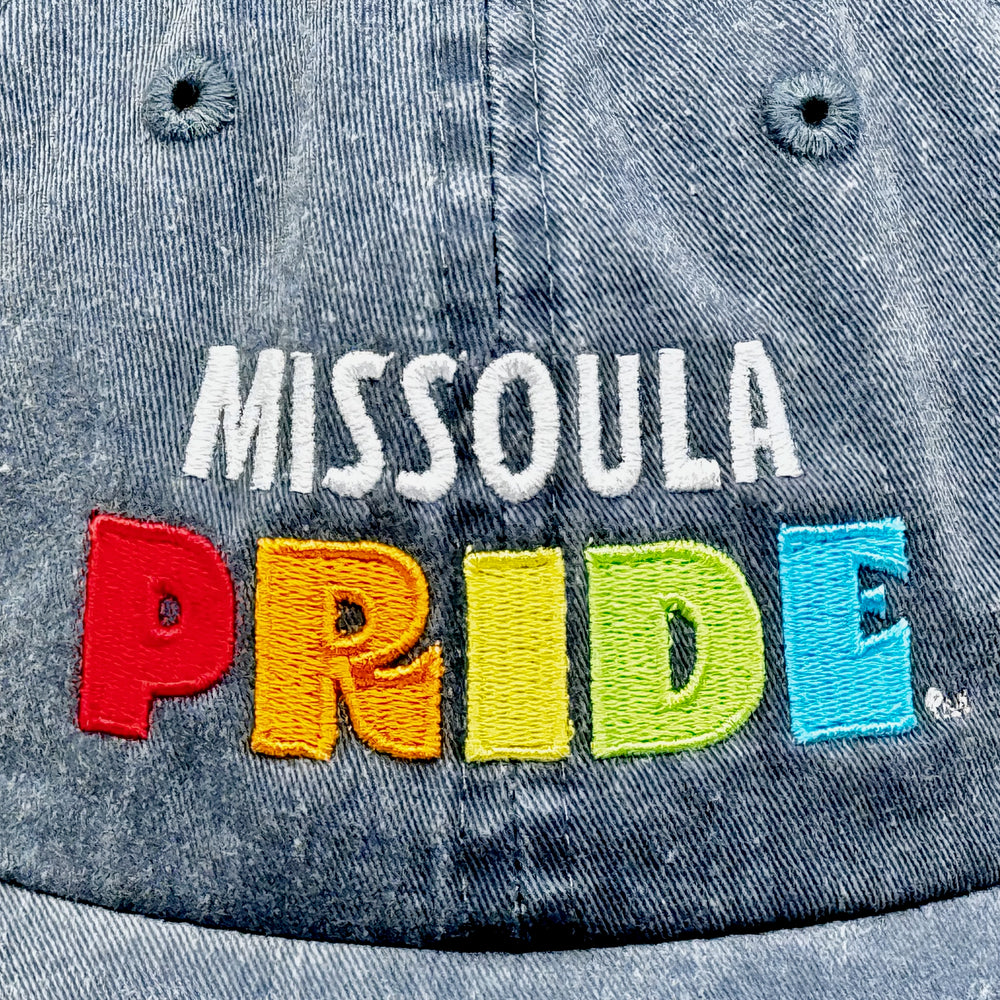 Charcoal grey pigment dyed unstructured hat featuring the Missoula PRIDE logo, detail