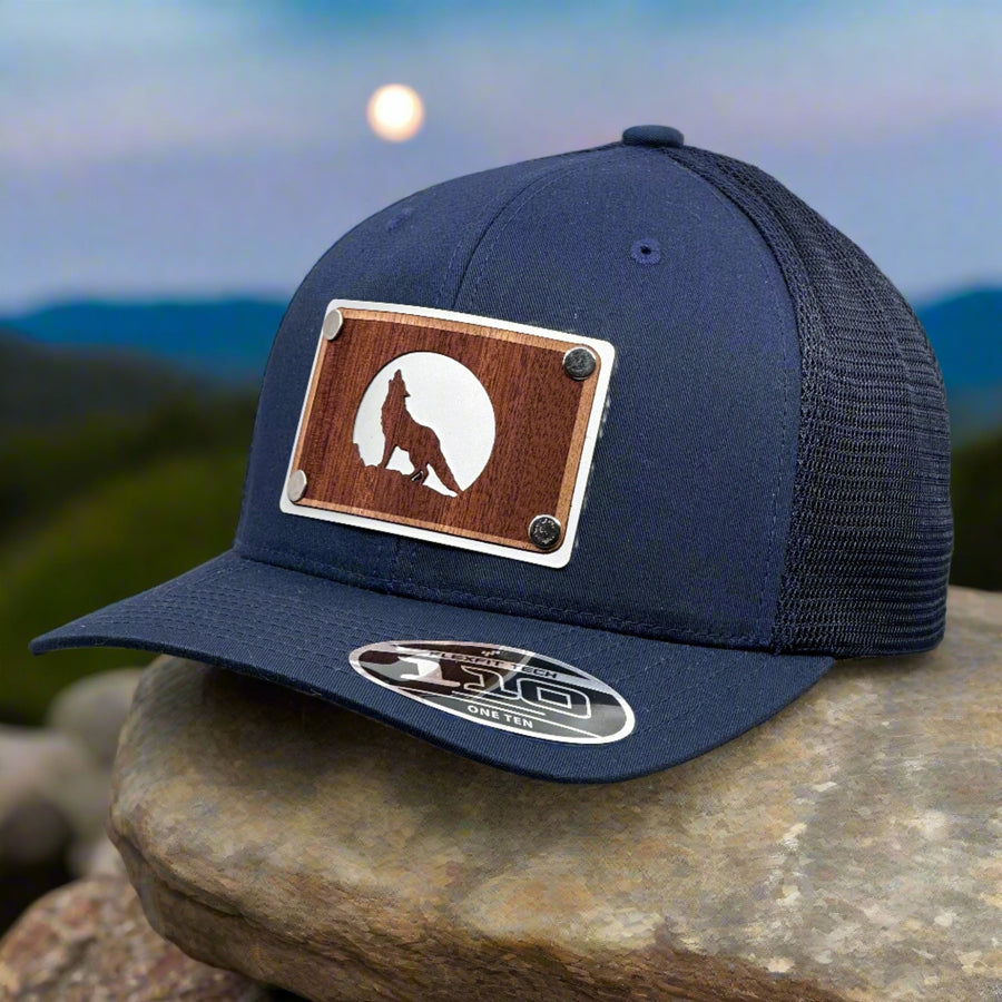 A mahogany wolf patch with a silver plate patch on a navy blue trucker hat