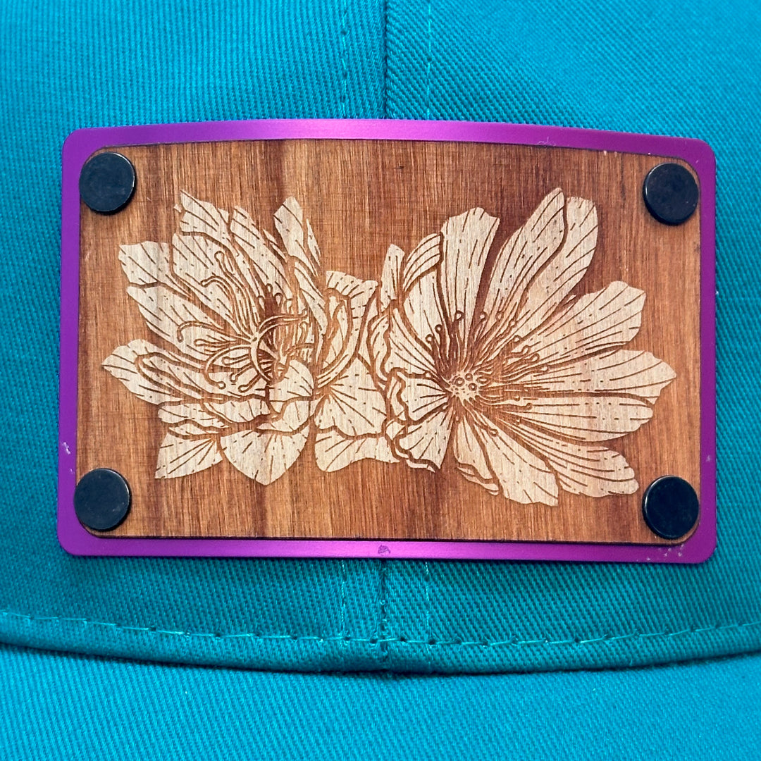 Bitterroot Cherry Wood Purple Metal Patch on Evergreen Eco Trucker Hat