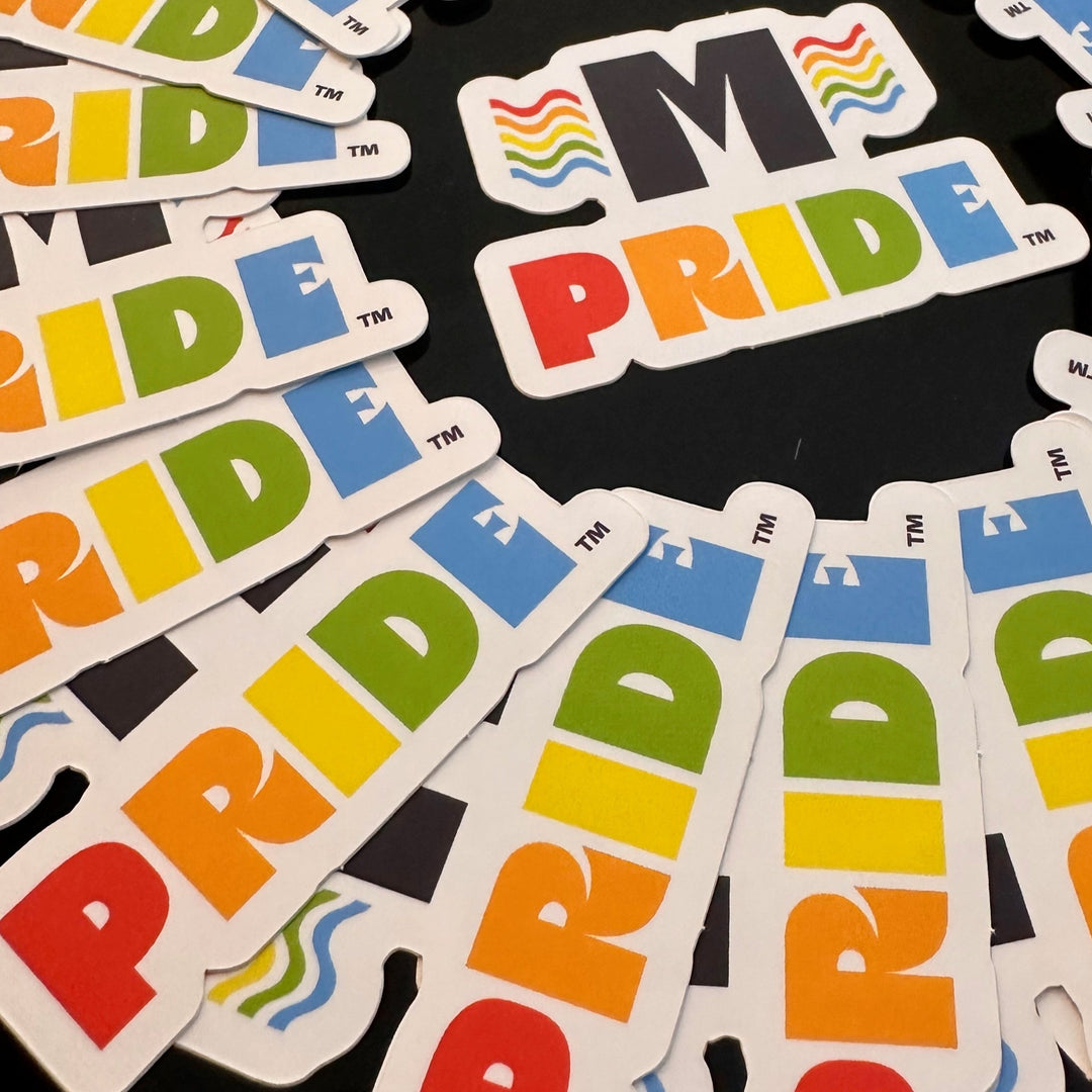 Circled group of Missoula PRIDE logo stickers, closeup