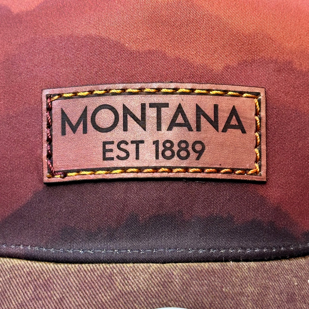 A close up of the thick stitched leather hat that says "Montana EST 1889"