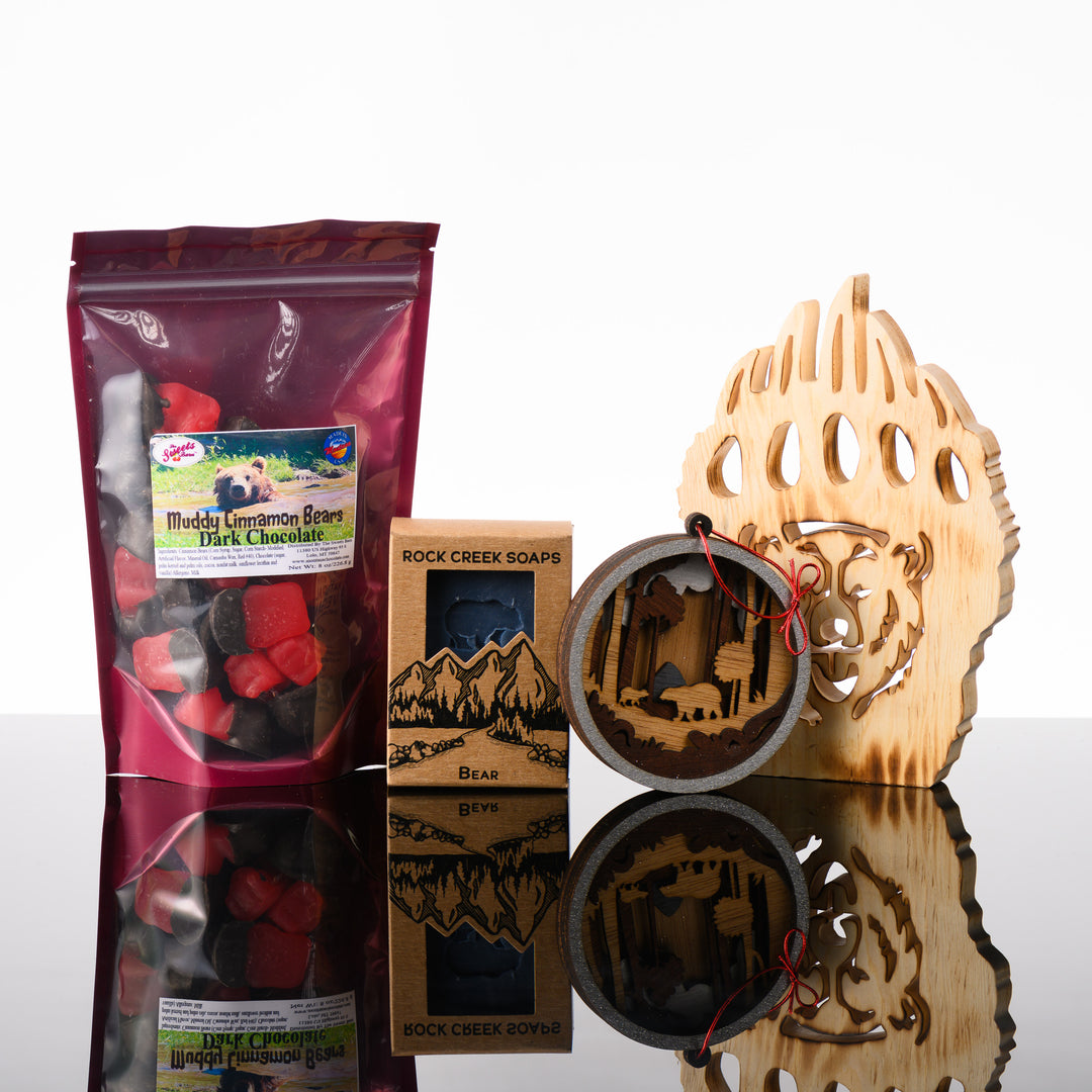 This Last Best Box features all made in Montana items including chocolate covered cinnamon gummy bears, Huckleberry soap with a bear stamp, a 3-D layered wood bear ornament and a wood bear paw with a bear face carved out of it.