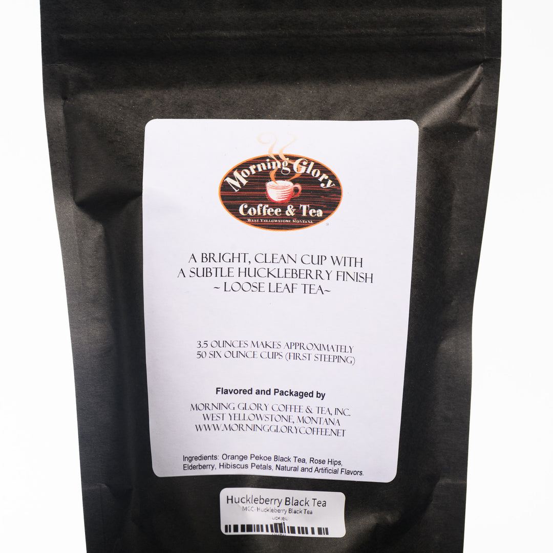 A bag of Morning Glory Coffee and Teas' 3.5oz bag of loose leaf Huckleberry Black Tea. The back reads Ingredients: Orange Pekoe Black Tea, Rose Hips, Elderberry, Hibiscus Petals, Natural and Artificial Flavors.