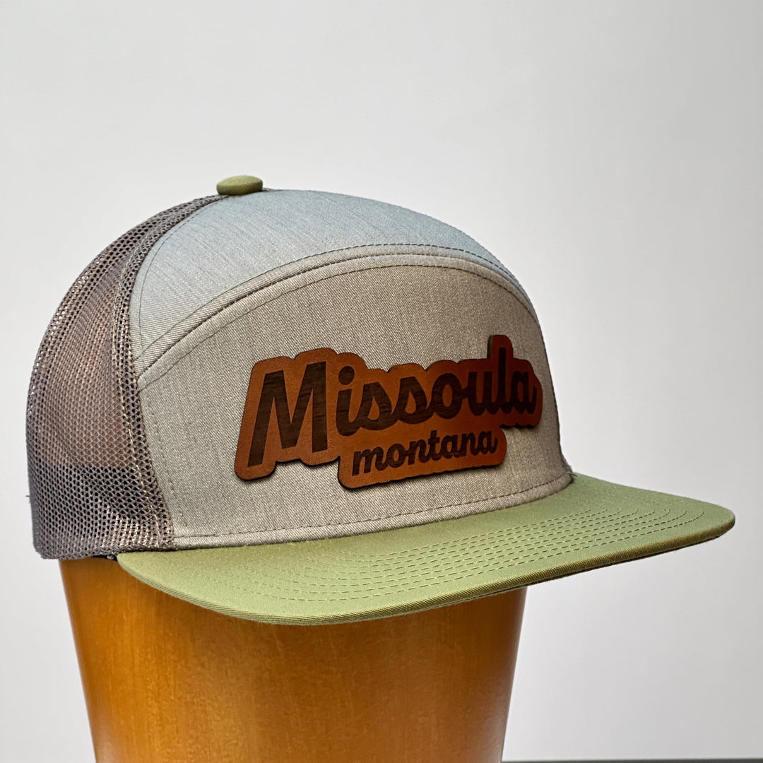 A hand dyed leather patch, made in Montana, spelling out the words Missoula Montana on a premium flatbill trucker hat