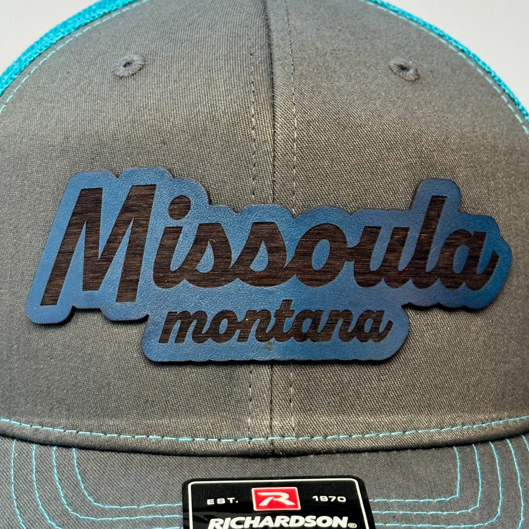 made in montana leather patch with missoula montana lettering. blue grey richardson trucker hat