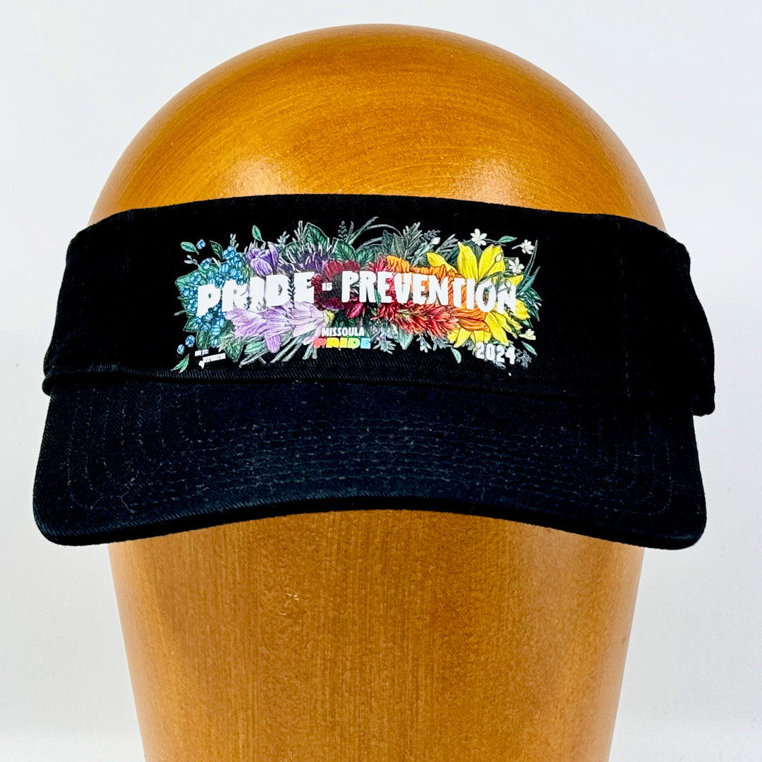 Black visor featuring the 2024 Missoula Pride design Pride is Prevention design; a portion of sales are donated to the Missoula Pride fundraiser.