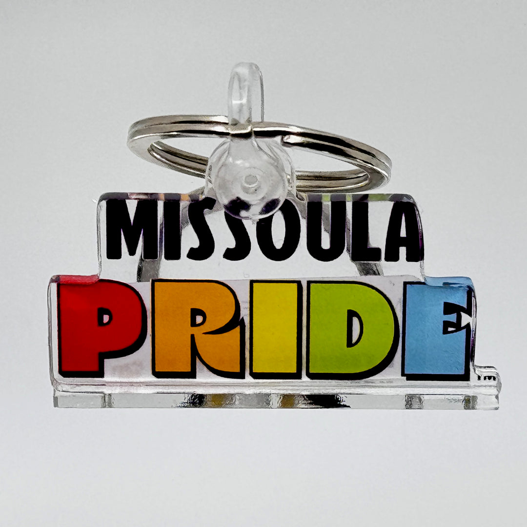 Keychain featuring the Missoula Pride logo; a portion of sales are donated to the Missoula Pride fundraiser.