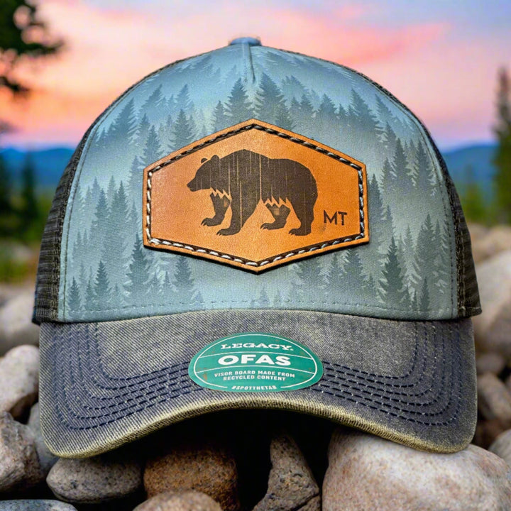 This is the front of a hand dyed leather patch, made in Montana, in the shape of a Bear with the letters MT underneath, legacy trucker hat