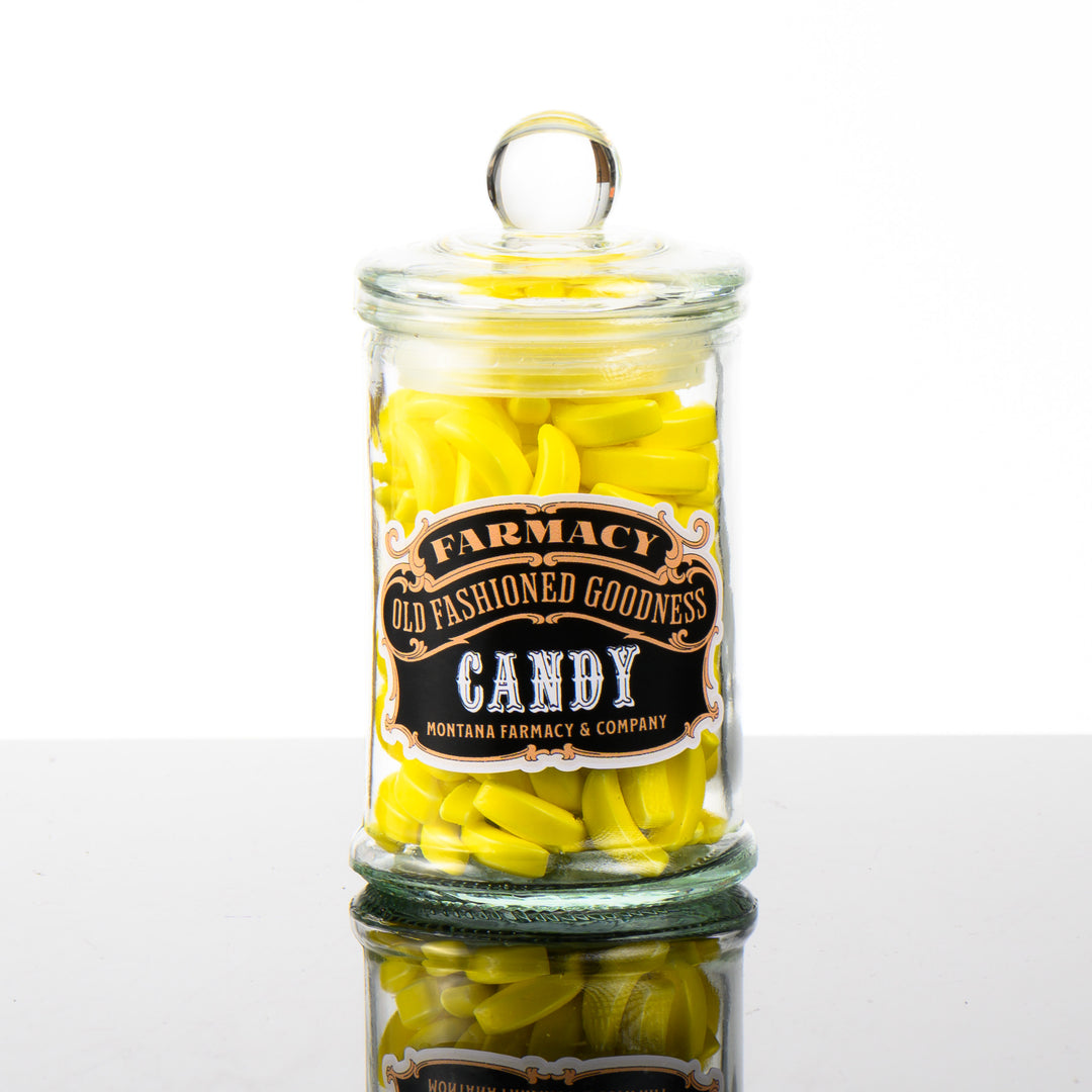 A old-fashioned glass candy  jar filled with banana runts