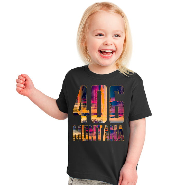 A happy toddler wearing a black tshirt with the colorful 406 Montana design.