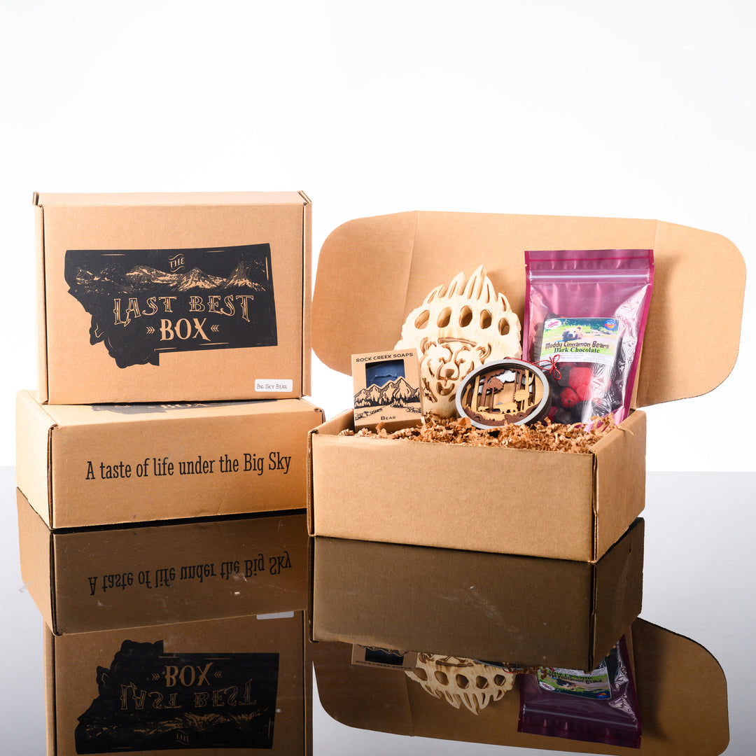 This Last Best Box features all made in Montana items including chocolate covered cinnamon gummy bears, Huckleberry soap with a bear stamp, a 3-D layered wood bear ornament and a wood bear paw with a bear face carved out of it.