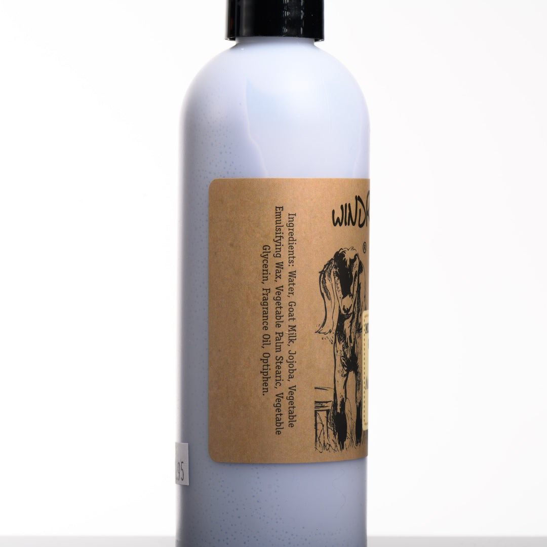 An 8 ounce bottle of Windrift Hill's made in Montana moisturizing goat milk lotion in sent Montana Huckleberry. The ingredients listed are: water, goat milk, Jojoba, vegetable emulsifying wax, vegetable palm stearic, vegetable glycerin, fragrance oil, optiphen