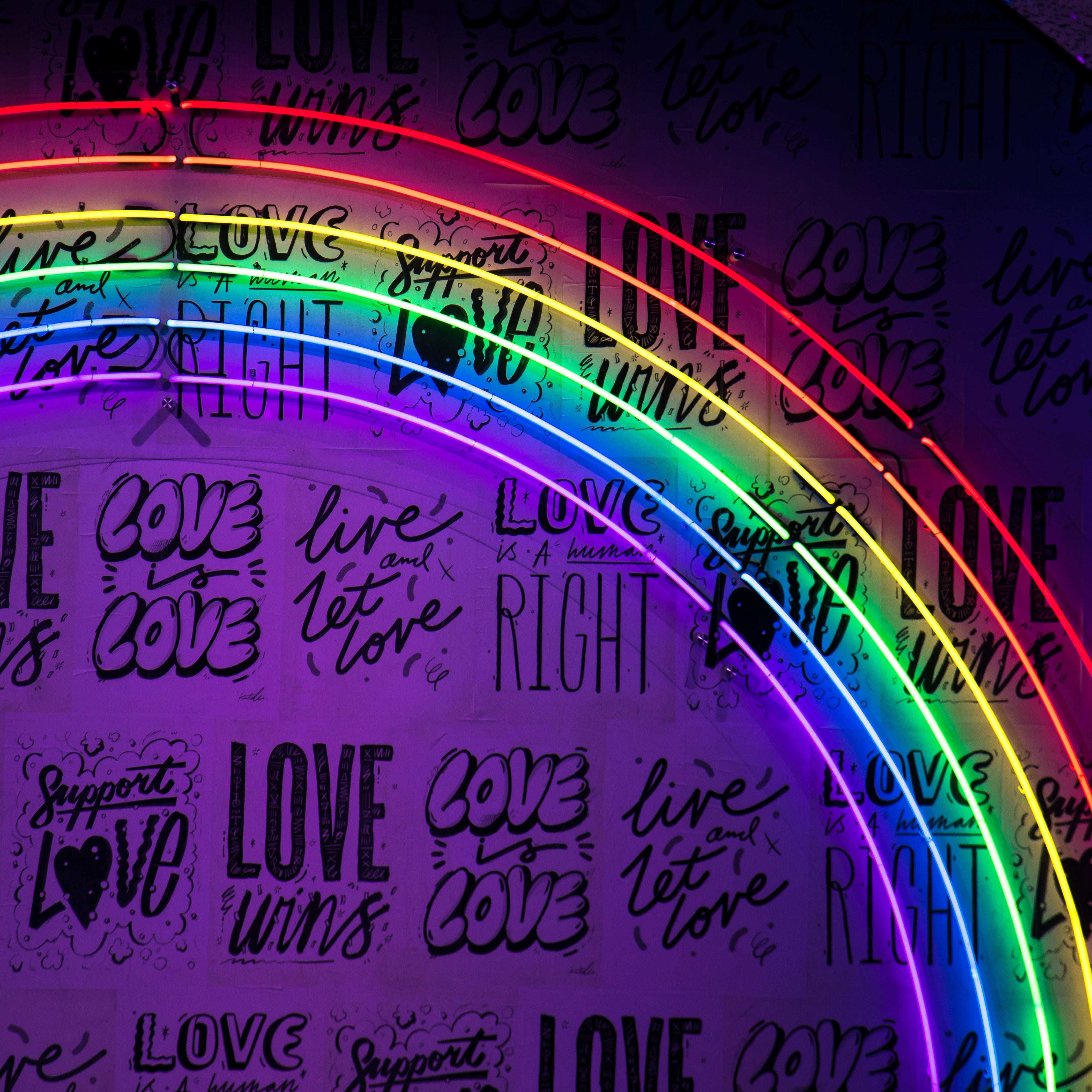 Neon rainbow against a love wall, representing the Rainbow Collection of Montana-made merchandise available at The Last Best Store.