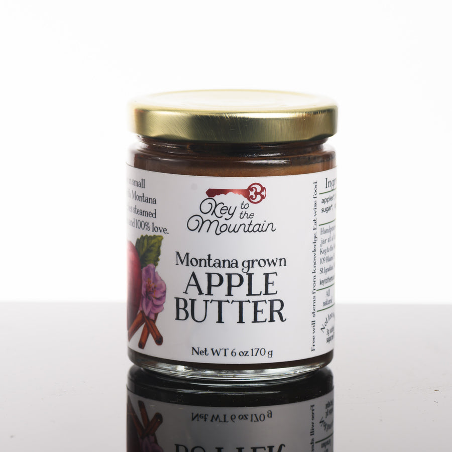 A picture of the front of a 6 ounce jar of Montana grown apple butter.