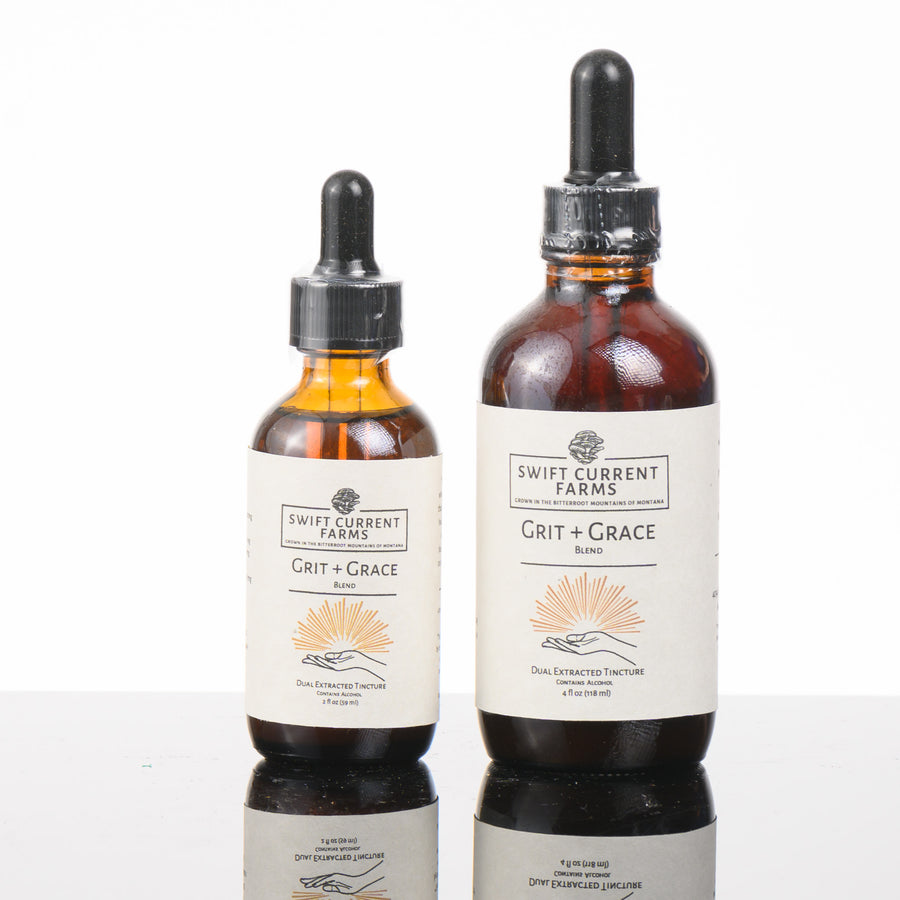 Two bottles of Swift Current Farms' Grit and Grace Blend Tincture, a masterful fusion of premium mushrooms.