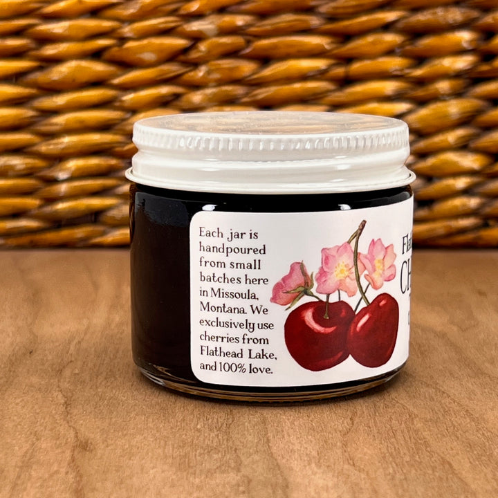 A 2oz jar of Key to the Mountain's handmade Montana flathead Lake Cherry jam reading handmade in small batches with Montana grown cherries, less sugar and 100% love.