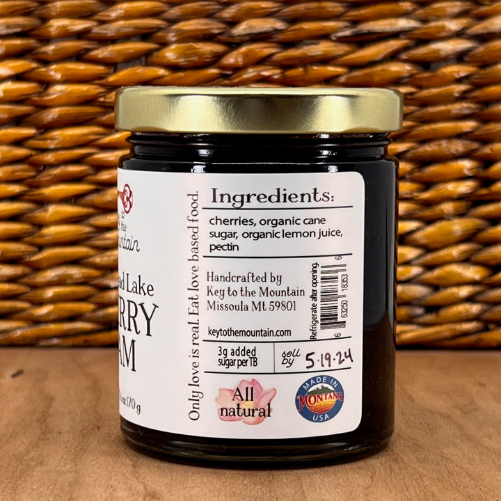 A 6oz Jar of Key to the Mountain's handmade Montana flathead Lake Cherry jam Ingredient's list: cherries, organic cane sugar, organic lemon juice, pectin