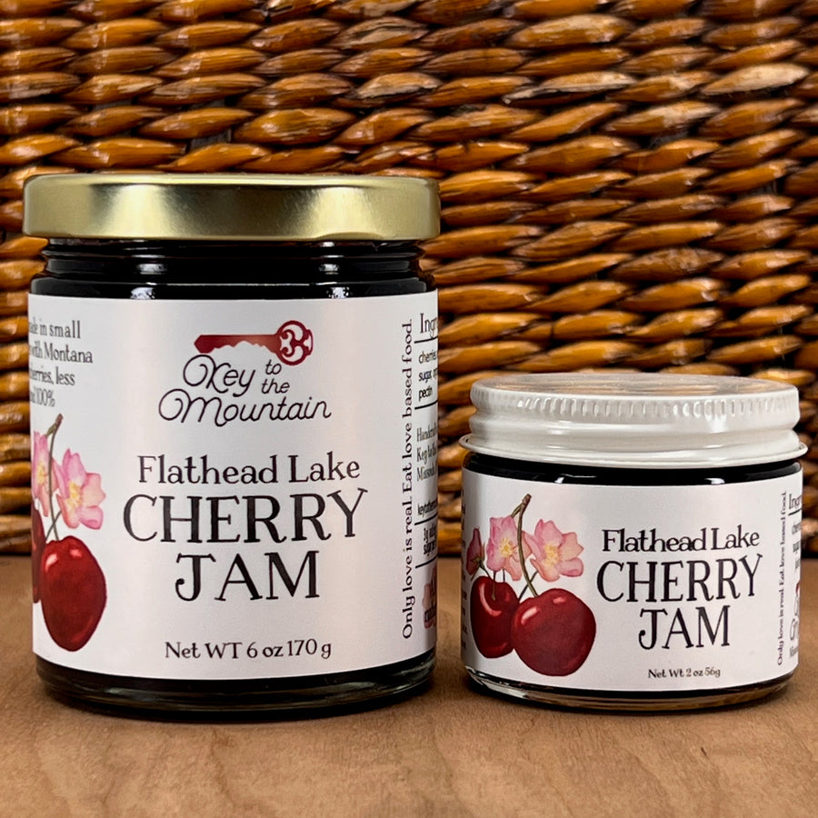 Two jars of Key to the Mountain's handmade Montana flathead Lake Cherry jam.