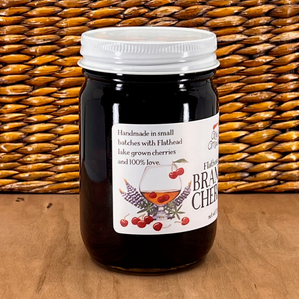 The side of a 12 ounce jar of Key to the Mountain's Montana made Flathead Lake brandied cherries reading Handmade in small batches with Flathead lake grown cherries and 100% love.