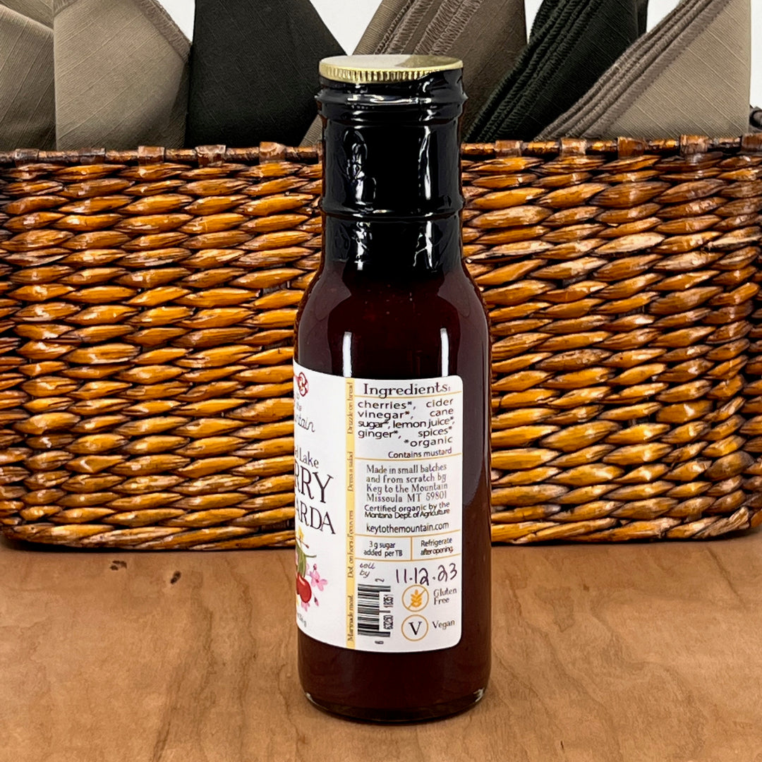 The ingredients of an 8 ounce bottle of Key to the Mountain's Flathead Lake Cherry Mostarda handmade in Montana. Ingredients: organic cherries, organic cider vinegar, organic cane sugar, organic lemon juice, organic ginger, organic spices