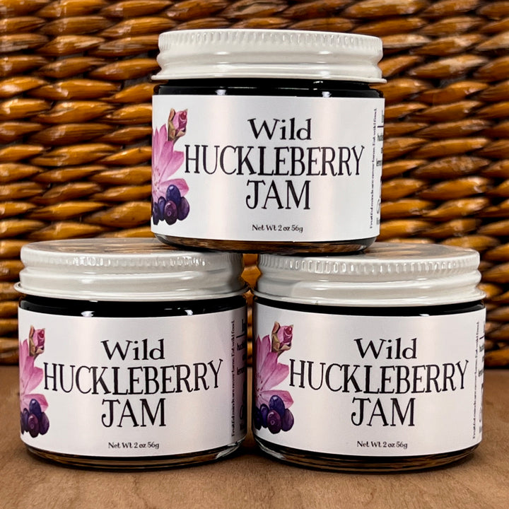 three stacked jars of Key to the Mountain's, Montana handmade Wild Huckleberry Jam.